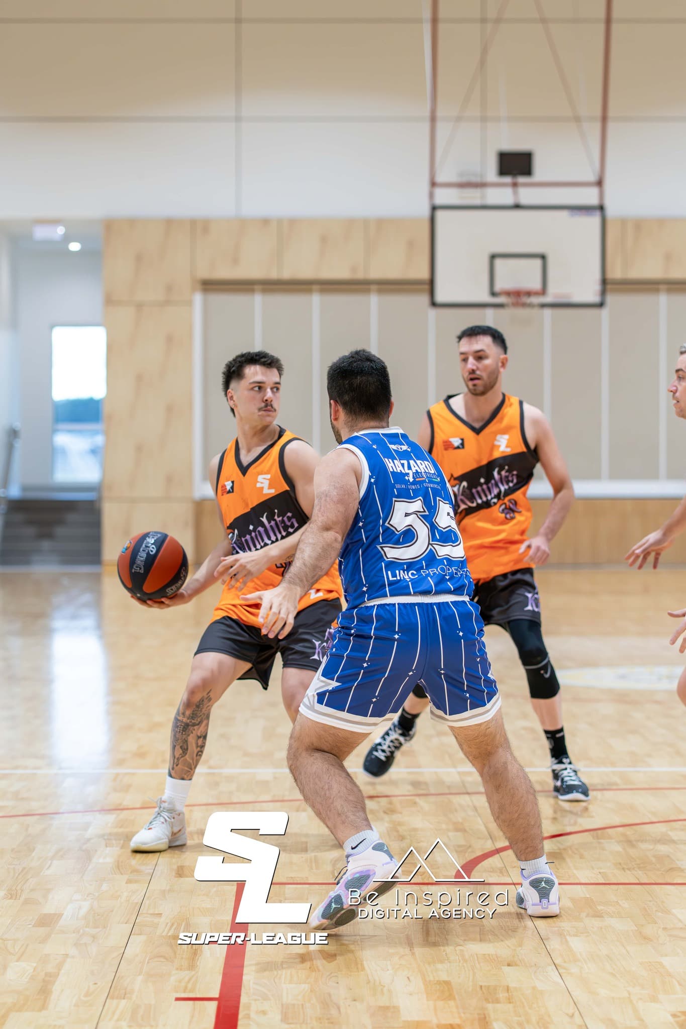 Super League basketball game action - players competing on court